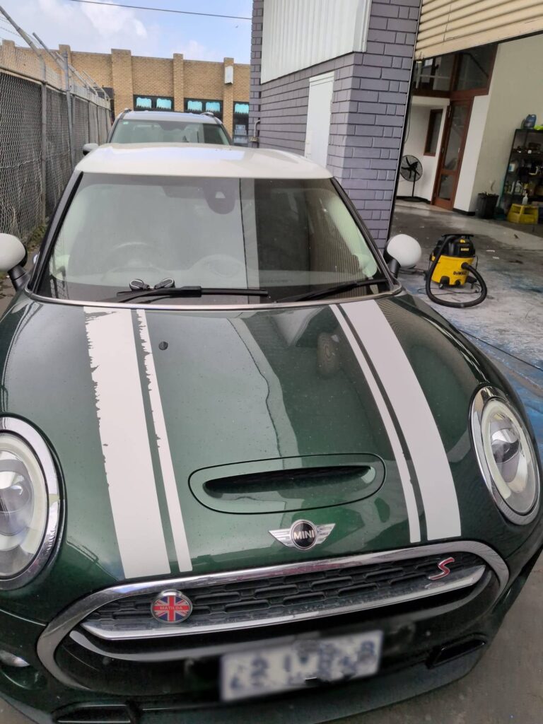 Fleet vehicle before cleaning – dirty Mini Cooper with old decals